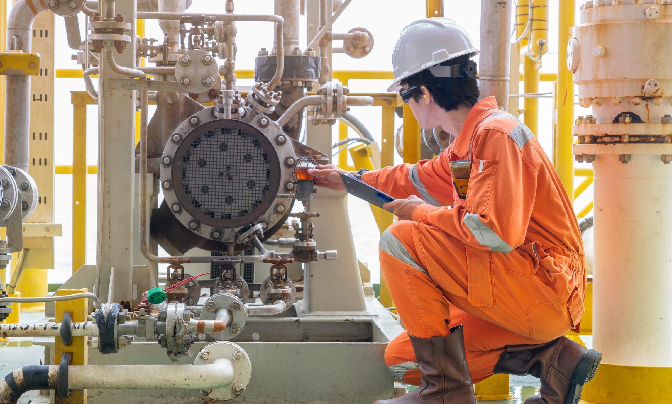 Mechanic inspector engineer check condition of crude oil centrifugal pump and lube oil system at offshore gas central processing platform, power and energy service business industry.